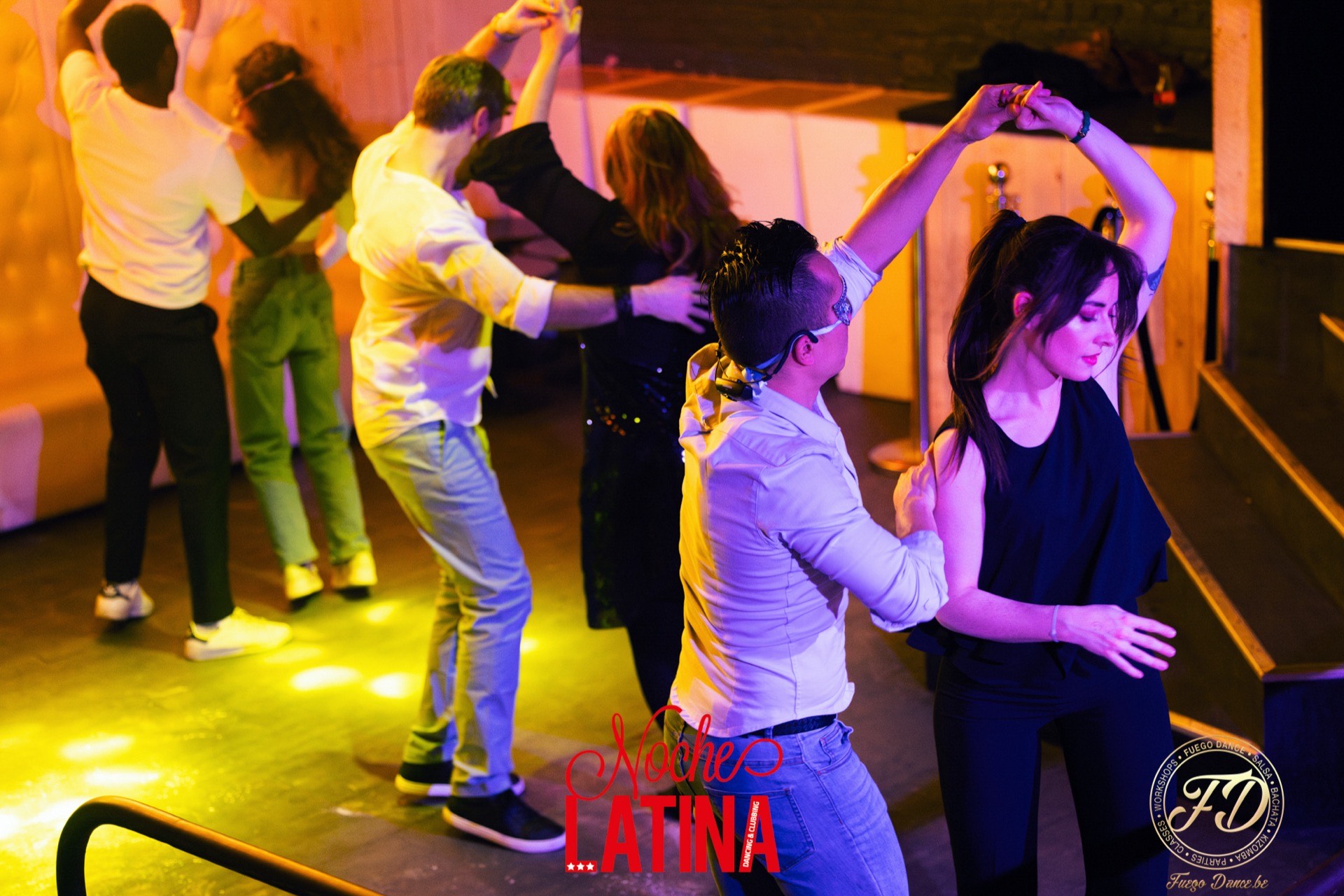 Couples dancing salsa at a Fuego Dance party