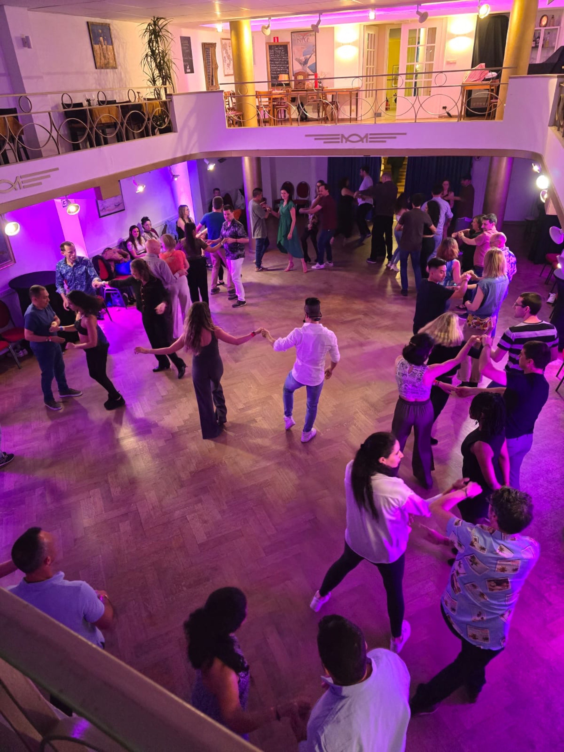 Social dancing with purple lighting
